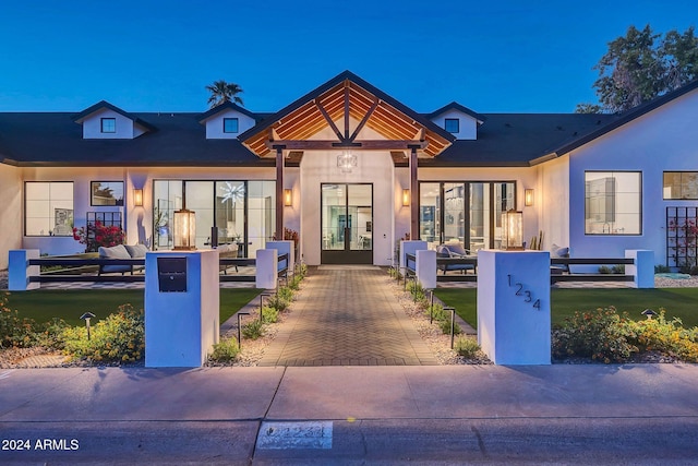 view of front facade featuring a fenced front yard, a front yard, and stucco siding