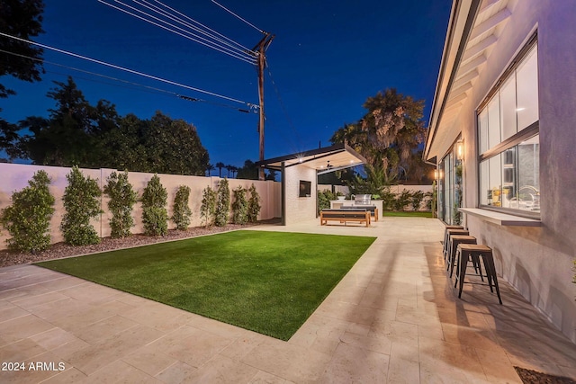 yard at twilight with a patio