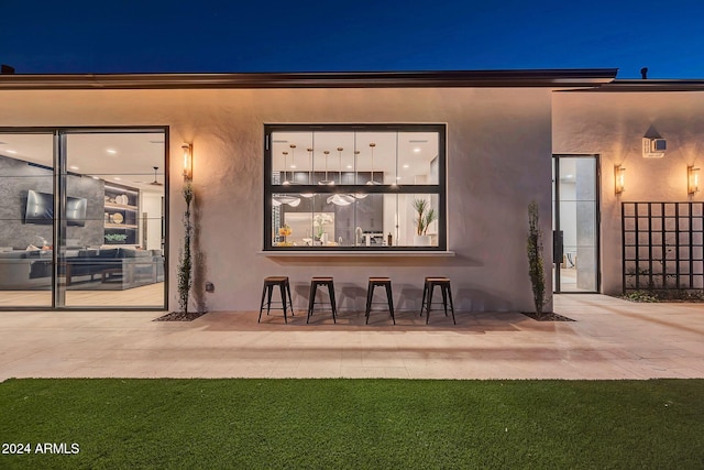 exterior entry at twilight with a patio area