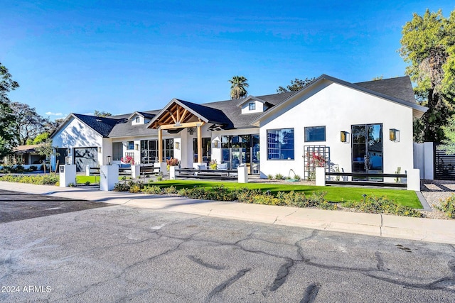 view of front of property with fence and stucco siding