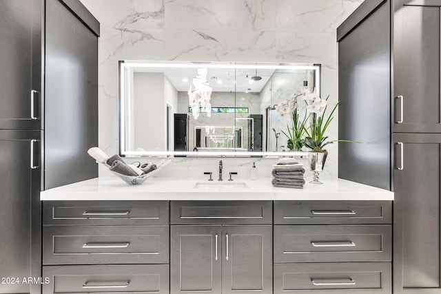 full bathroom with a stall shower and vanity