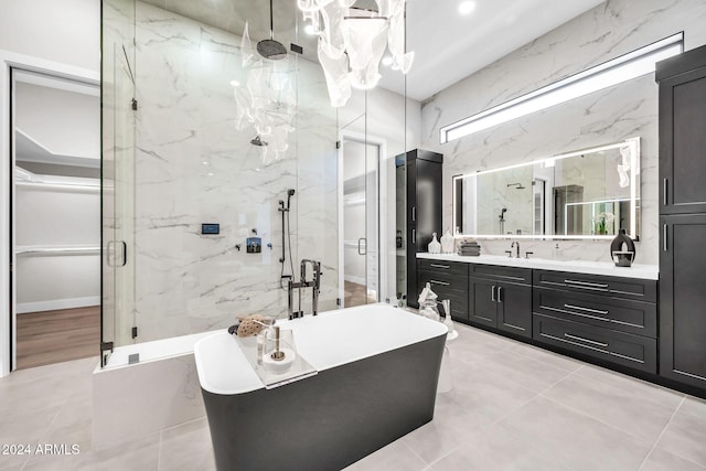 bathroom with vanity, shower with separate bathtub, and tile patterned flooring