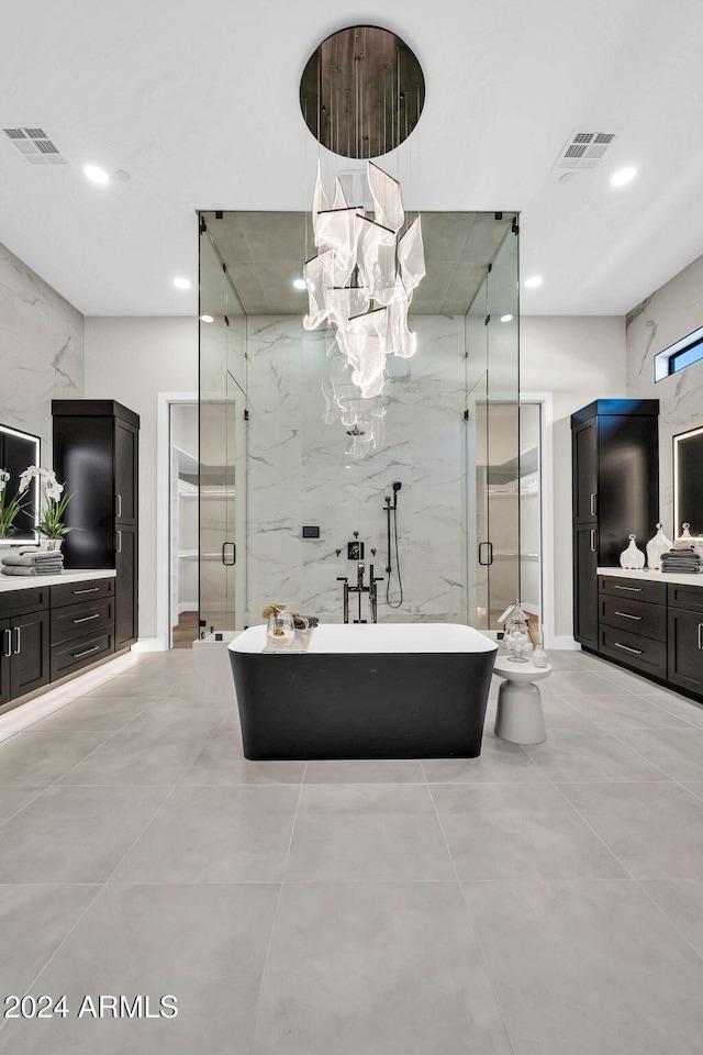 bathroom with visible vents, a freestanding bath, vanity, and a shower stall