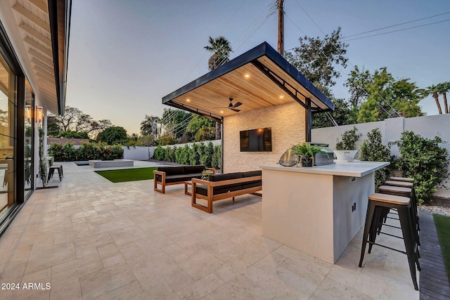 view of patio / terrace with outdoor dry bar, outdoor lounge area, and a fenced backyard