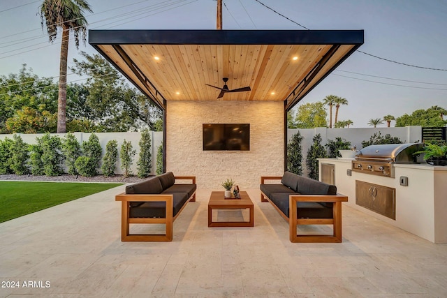 view of patio / terrace with an outdoor kitchen, area for grilling, a fenced backyard, ceiling fan, and an outdoor hangout area