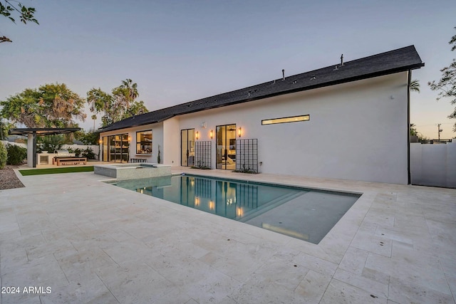 view of pool featuring a patio area, area for grilling, fence, and a pool with connected hot tub