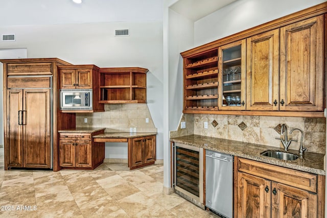 kitchen with visible vents, open shelves, a sink, wine cooler, and built in appliances