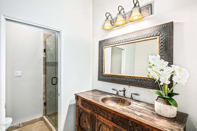 full bathroom with toilet, a stall shower, and vanity