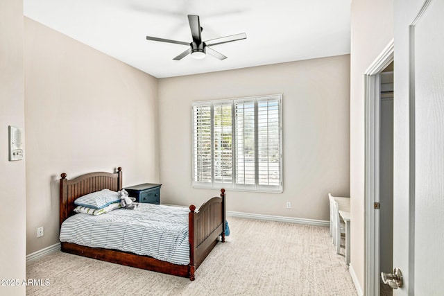 carpeted bedroom with a ceiling fan and baseboards