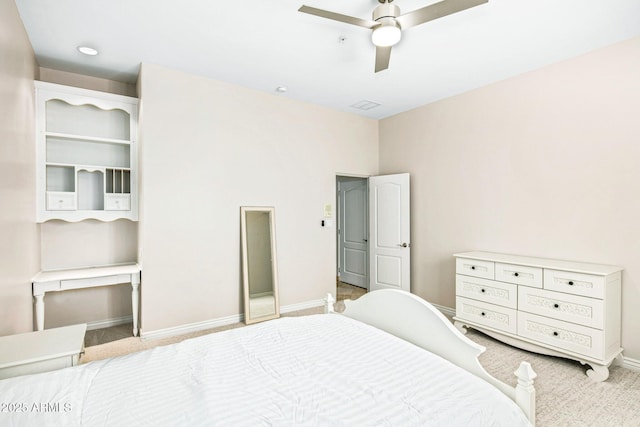 carpeted bedroom featuring baseboards and ceiling fan