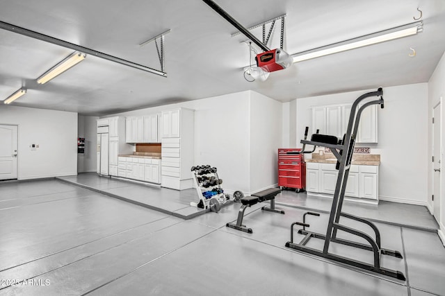 workout room with a garage and baseboards