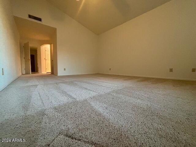 spare room featuring lofted ceiling and carpet floors