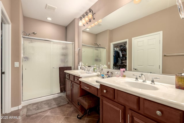 7504 W Patriot Way, Florence, AZ 85132 - full bath featuring a stall shower, double vanity, tile patterned flooring, and a spacious closet