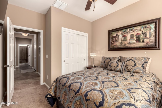 7504 W Patriot Way, Florence, AZ 85132 - carpeted bedroom with a closet, ceiling fan, and tile patterned floors