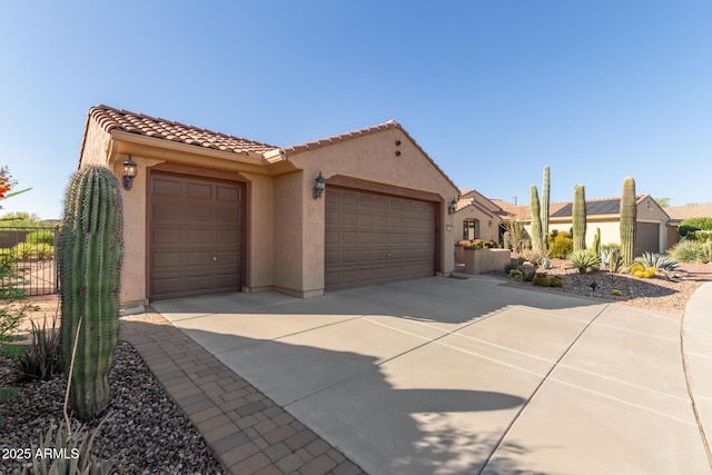 7504 W Patriot Way, Florence, AZ 85132 - mediterranean / spanish-style home with stucco siding, an attached garage, a tiled roof, and driveway