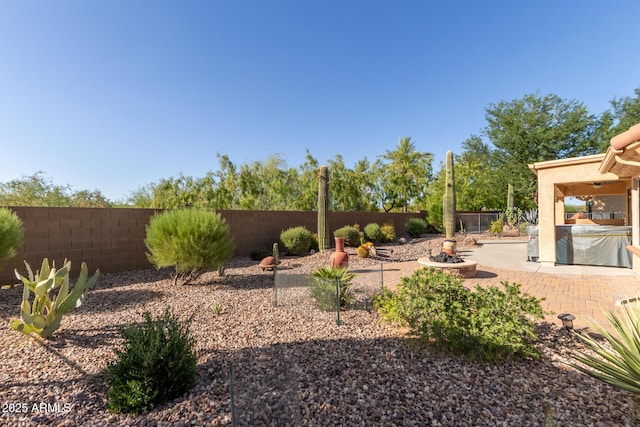 7504 W Patriot Way, Florence, AZ 85132 - fenced backyard featuring a patio and an outdoor fire pit