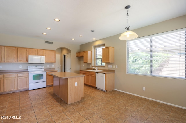 kitchen with a center island, sink, hanging light fixtures, white appliances, and light tile patterned floors