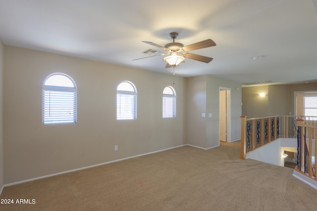 unfurnished room featuring light carpet and ceiling fan