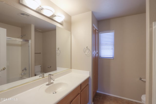 bathroom with tile patterned flooring, vanity, and toilet