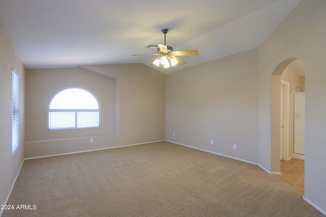 unfurnished room with light carpet, ceiling fan, and lofted ceiling