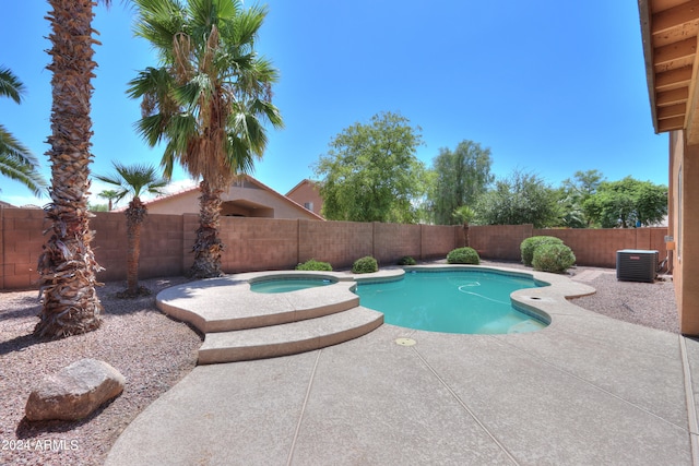 view of pool featuring an in ground hot tub, a patio, and central AC unit