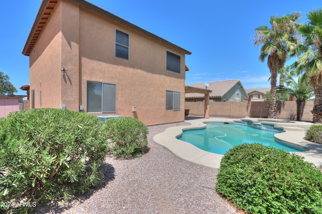 view of pool featuring an in ground hot tub