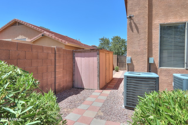 view of patio / terrace featuring central AC and a storage unit