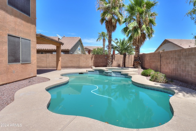 view of swimming pool with an in ground hot tub