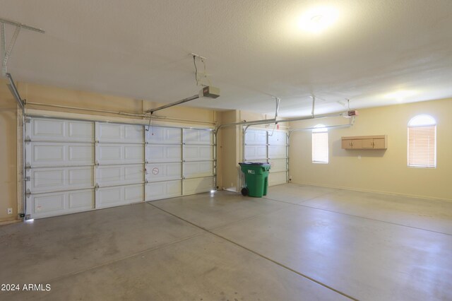 garage featuring gas water heater and a garage door opener