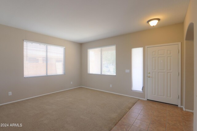 interior space featuring light tile patterned floors and an inviting chandelier