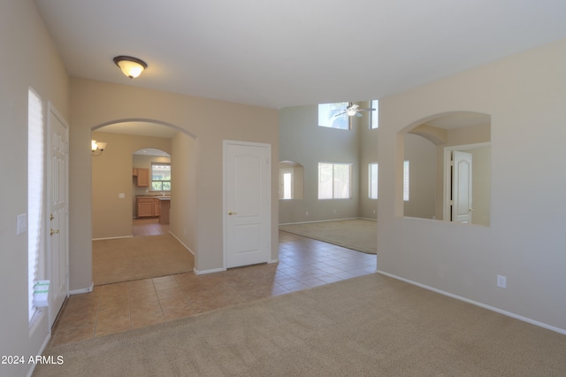 carpeted spare room with ceiling fan