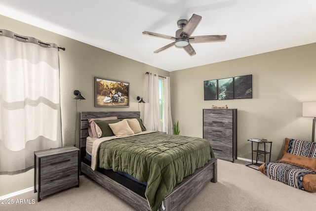 bedroom with ceiling fan and light carpet