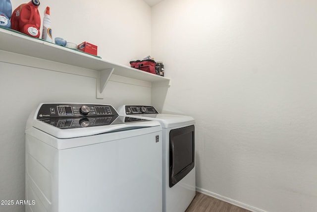 laundry area featuring separate washer and dryer and wood-type flooring