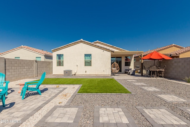 rear view of property with a patio and central air condition unit