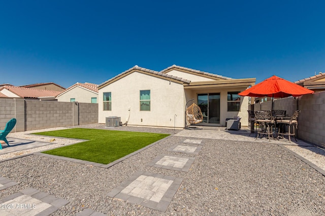 rear view of property with a patio area and central air condition unit