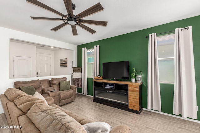 living room with ceiling fan and light wood-type flooring