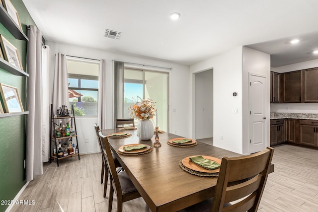 dining space with light hardwood / wood-style flooring