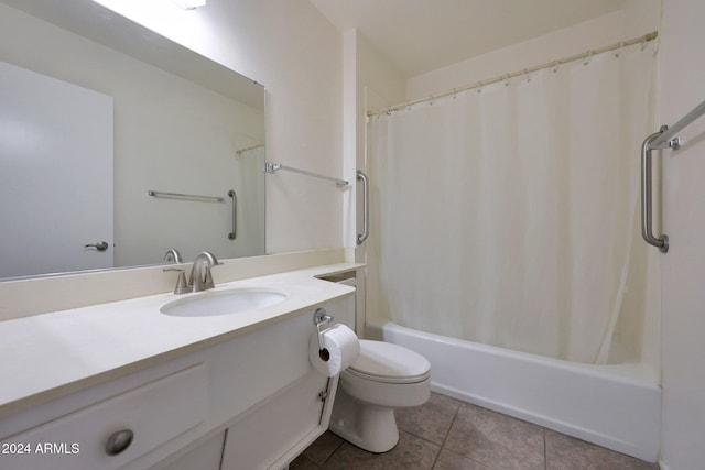 bathroom with toilet, vanity, and tile patterned floors