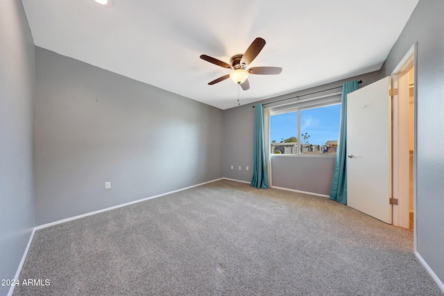 spare room featuring ceiling fan and carpet floors