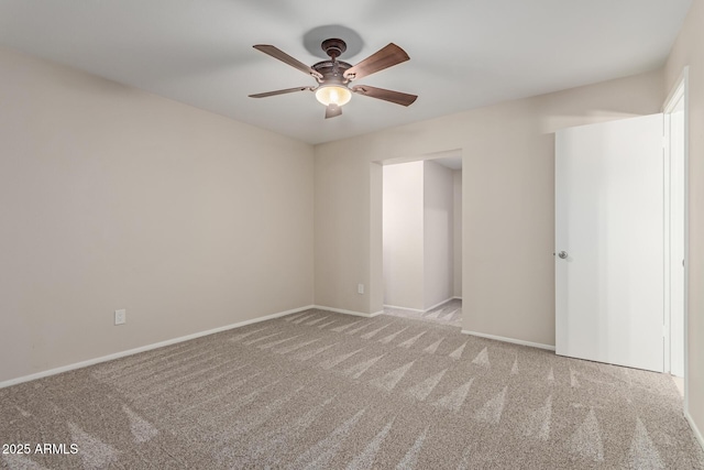 unfurnished room featuring carpet floors, baseboards, and ceiling fan