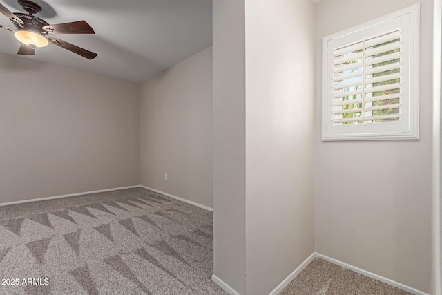 empty room with carpet floors, baseboards, and a ceiling fan