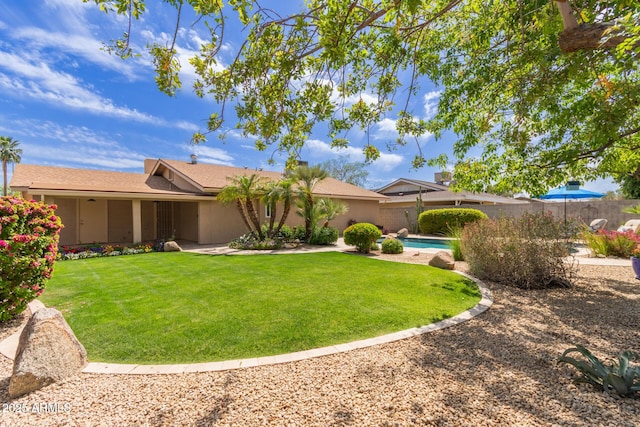 view of front of home with a fenced in pool, a front lawn, and fence