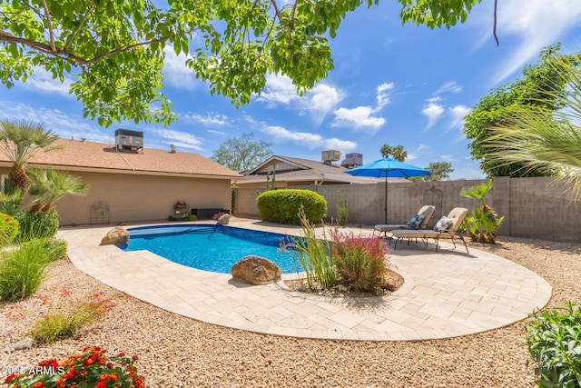 view of swimming pool featuring a fenced in pool, a fenced backyard, a patio area, and cooling unit