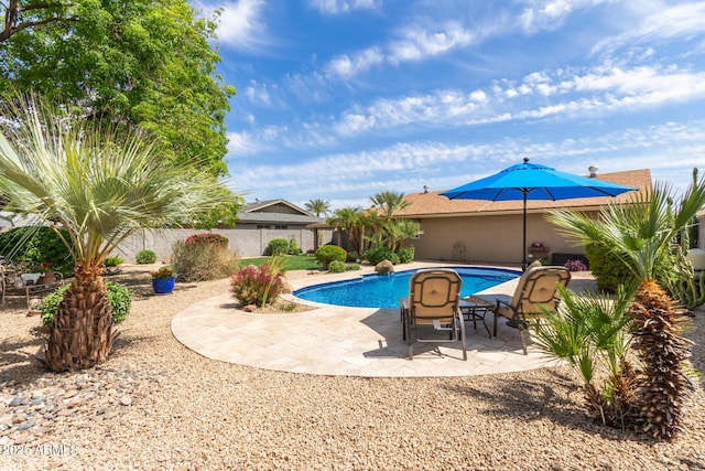 view of pool featuring fence, a fenced in pool, and a patio area
