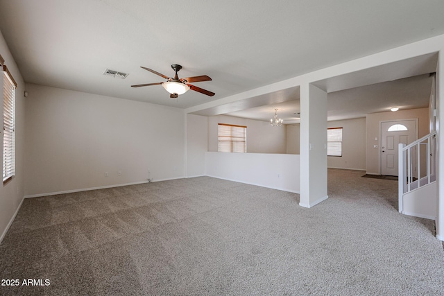4804 S 25th Dr, Phoenix, AZ 85041 - carpeted spare room featuring healthy amount of natural light, a ceiling fan, a chandelier, and baseboards