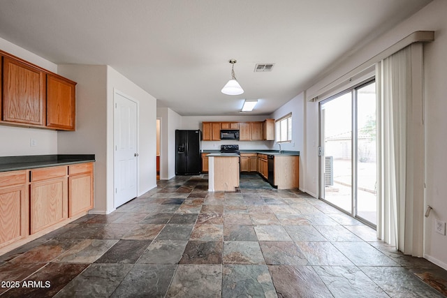 4804 S 25th Dr, Phoenix, AZ 85041 - kitchen featuring stone tile flooring, black appliances, baseboards, dark countertops, and a sink