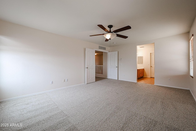 4804 S 25th Dr, Phoenix, AZ 85041 - unfurnished bedroom featuring light colored carpet, baseboards, ensuite bathroom, and a ceiling fan