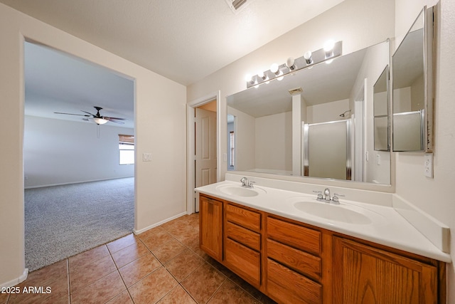 4804 S 25th Dr, Phoenix, AZ 85041 - bathroom featuring double vanity, a stall shower, ceiling fan, tile patterned floors, and baseboards