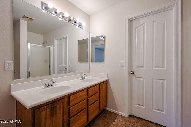 4804 S 25th Dr, Phoenix, AZ 85041 - full bathroom featuring double vanity, a stall shower, tile patterned flooring, and baseboards