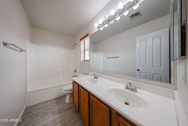 4804 S 25th Dr, Phoenix, AZ 85041 - bathroom featuring toilet, double vanity, bathing tub / shower combination, and wood finished floors